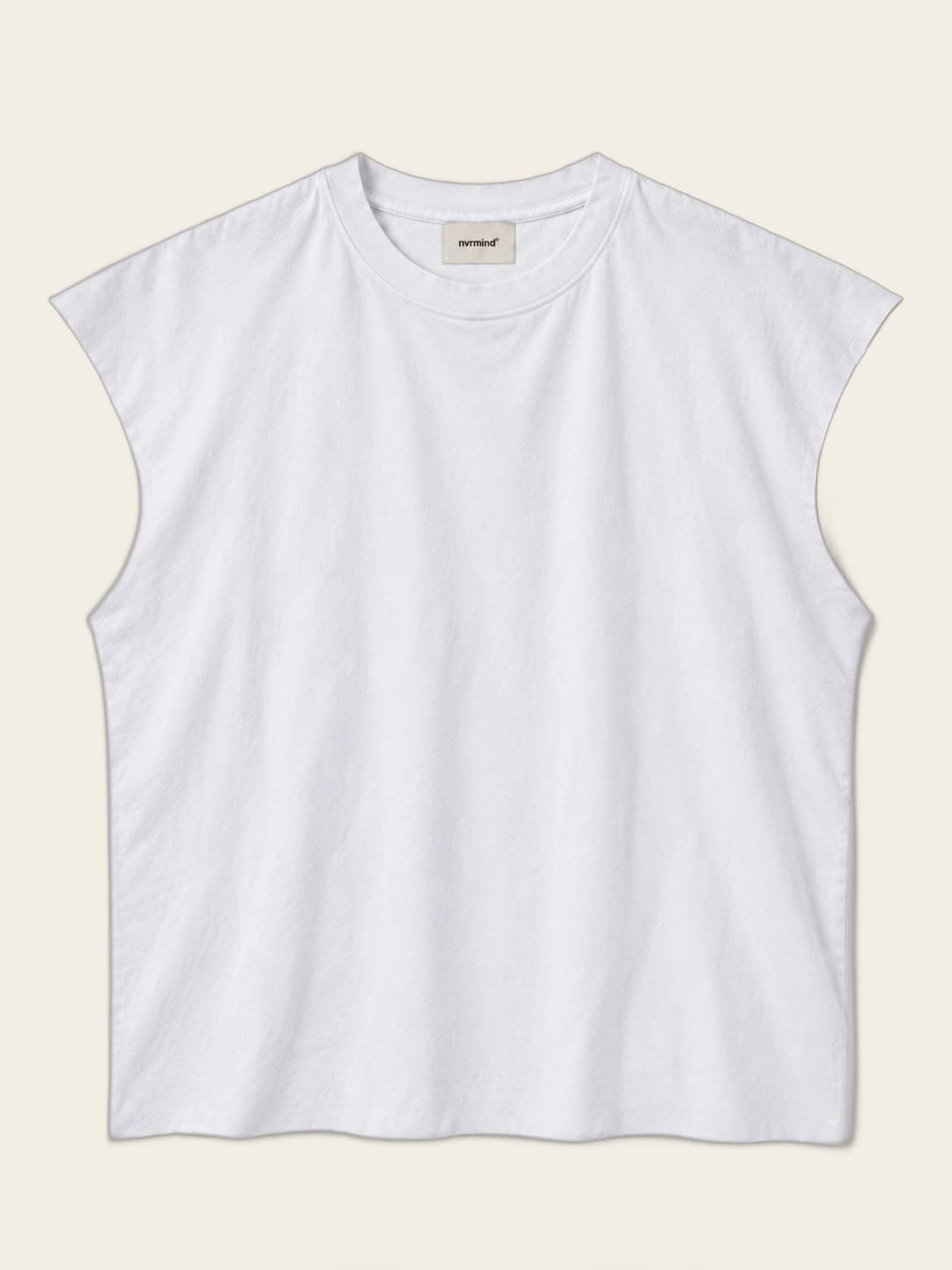 Sleeveless, worn against a sunlit wall.