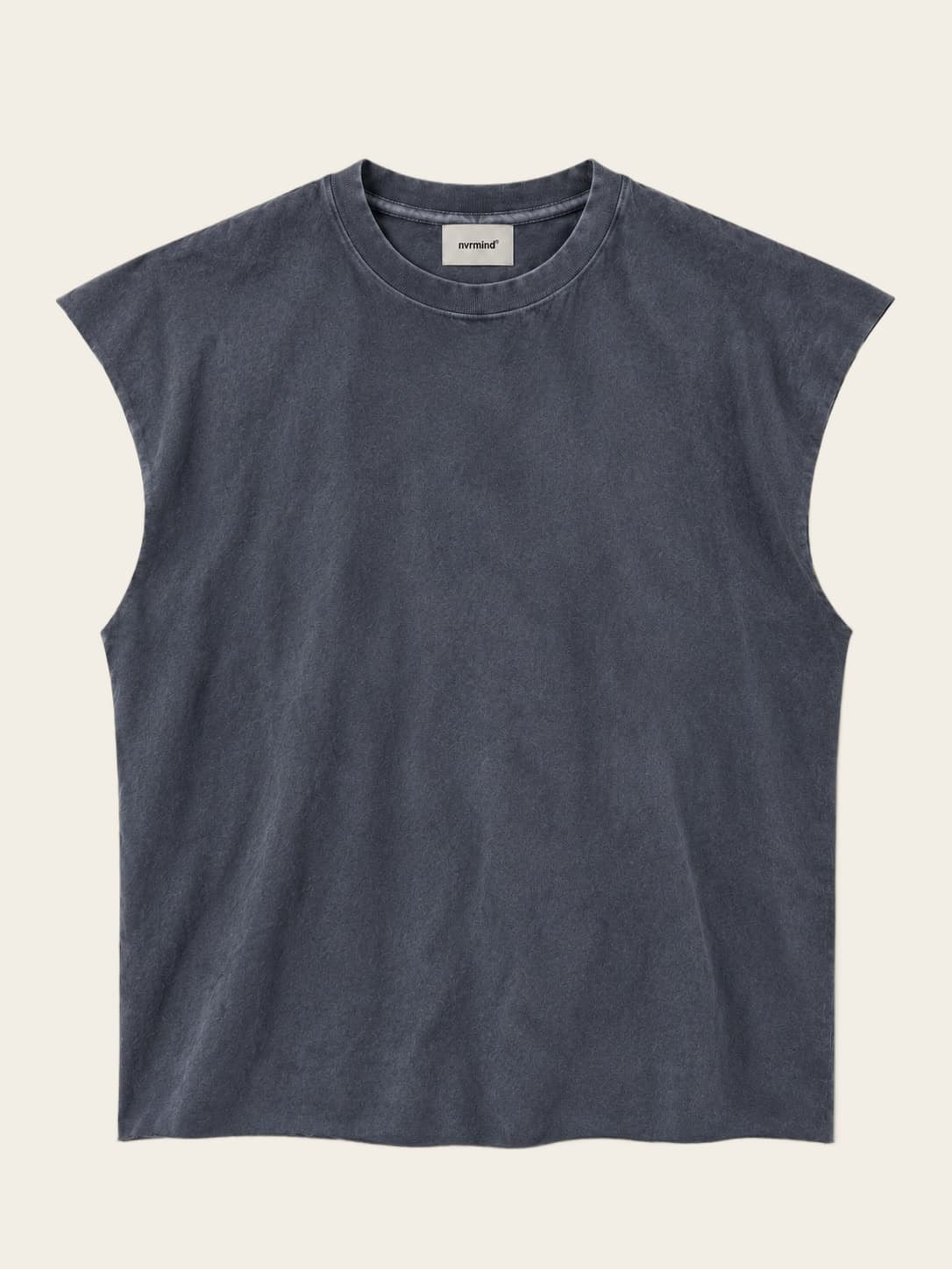 Sleeveless, worn against a sunlit wall.