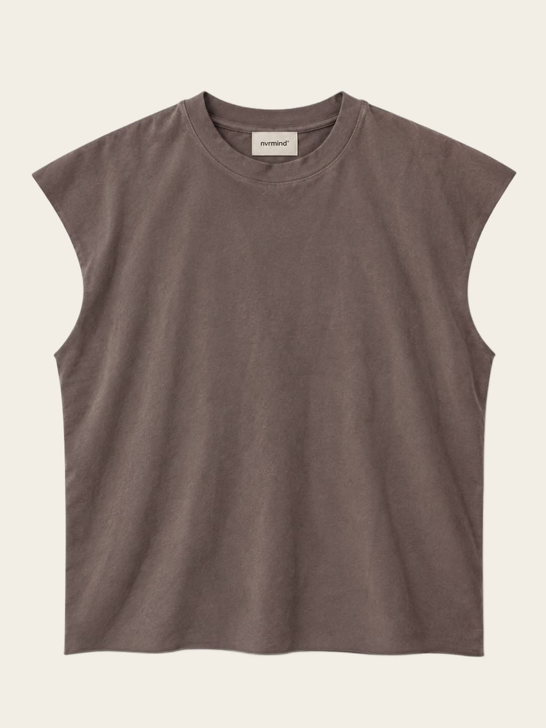 Sleeveless, worn against a sunlit wall.