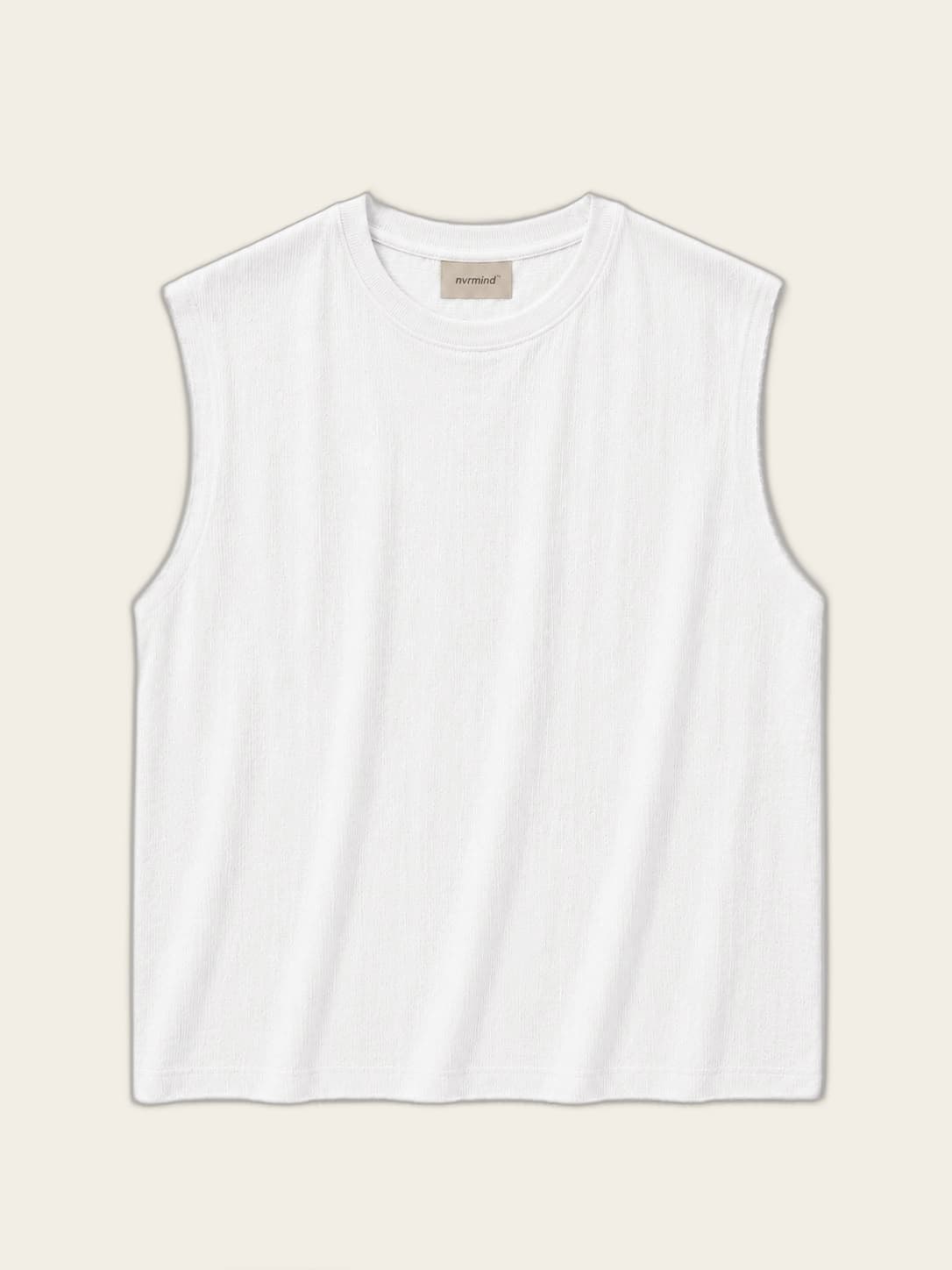 Sleeveless, worn against a sunlit wall, view 1 of 3.